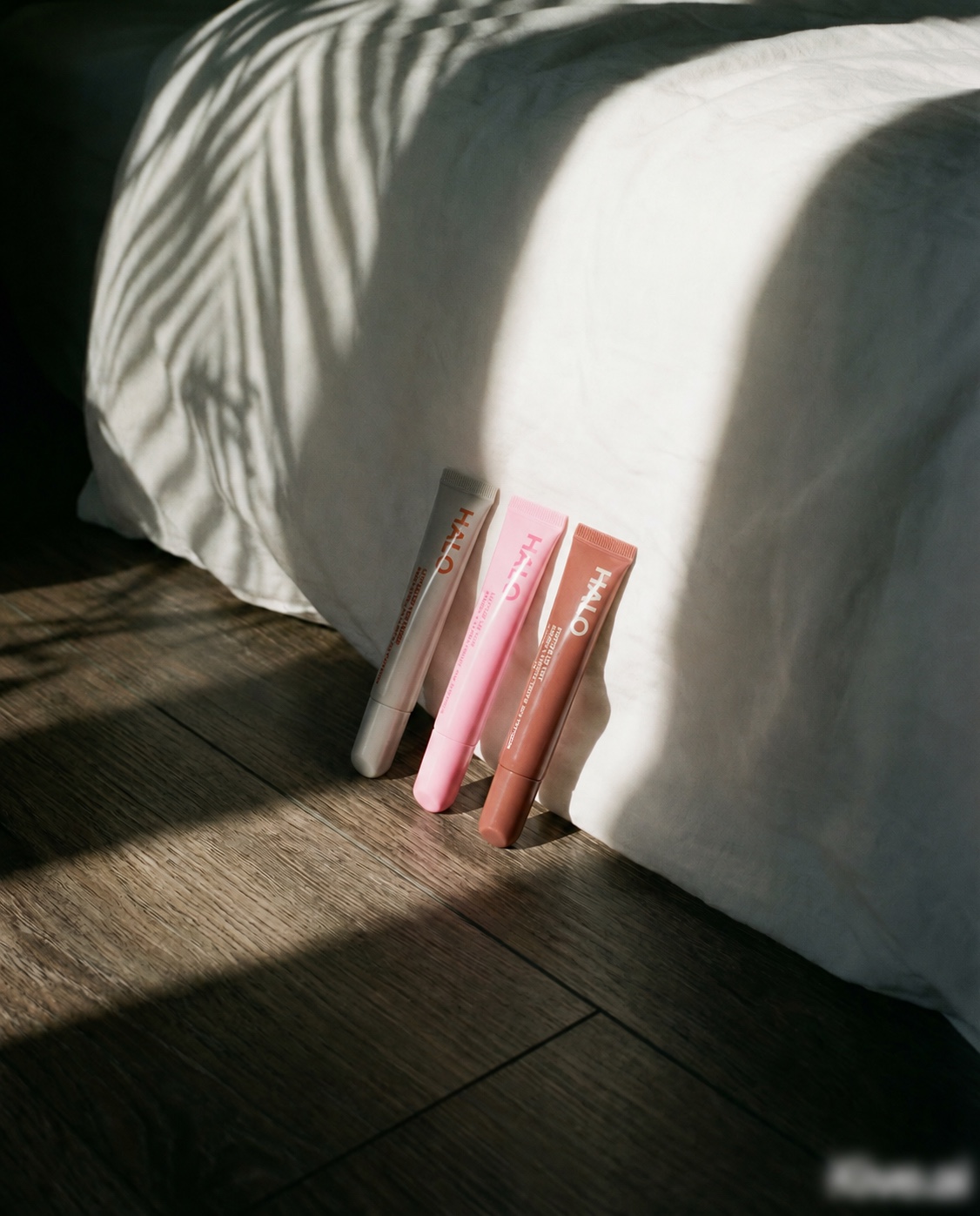 Three Halo peptide lip tint shades in morning light